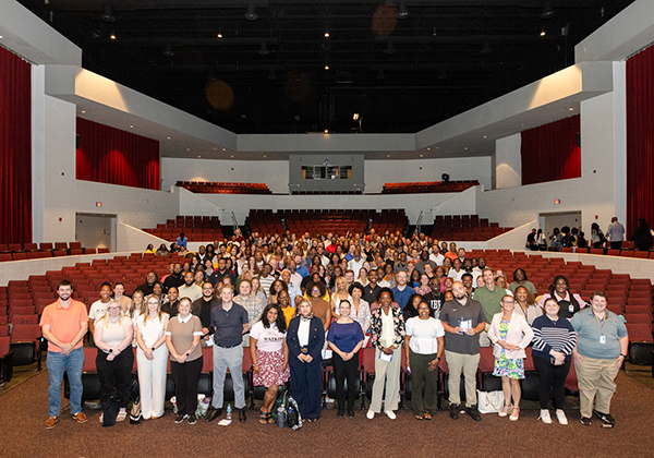 Hundreds of employees gathered inside a auditorium for new employee orientation event.
